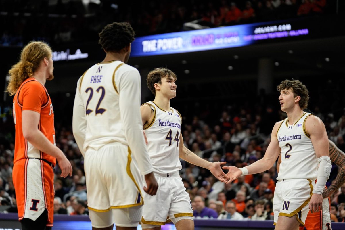 A basketball player low-fives two teammates after making a free throw.