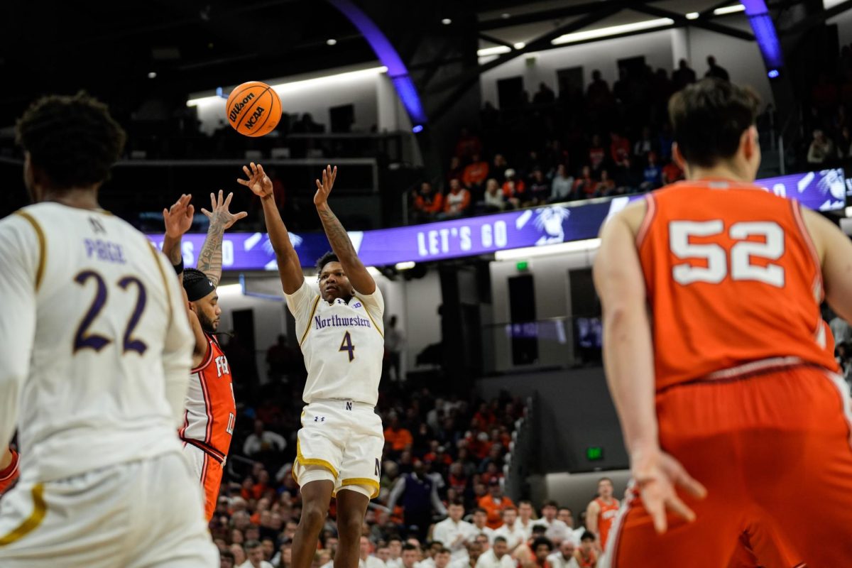 A basketball player jumps with their arms reaching up to make a shot.