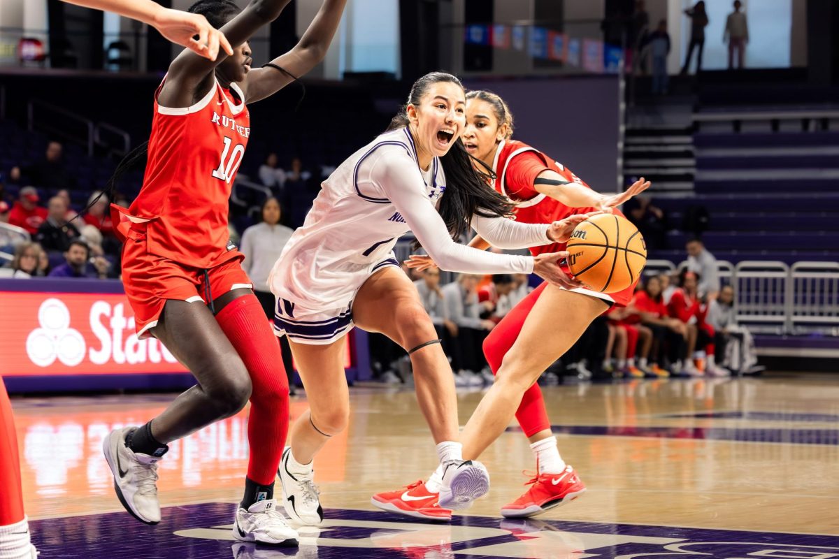 A Northwestern player cries out in frustration after being fouled by a Rutgers defender.
