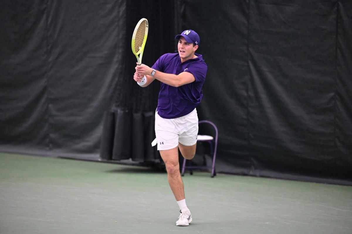 An athlete swings a tennis racket to return the ball.