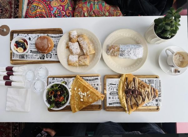 An arrangement of food sits on top of white table cloth.