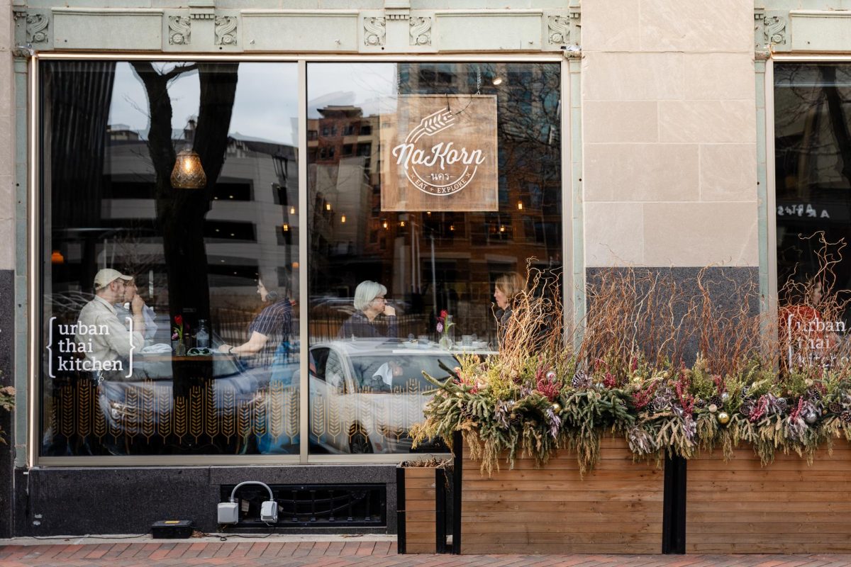 The front of a restaurant with a sign that reads “NaKorn” hanging in the window.