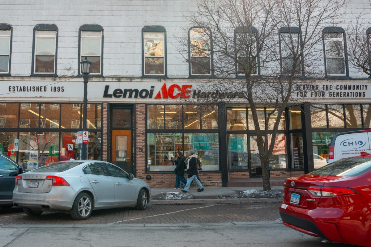 People walk past the Lemoi Ace Hardware storefront.