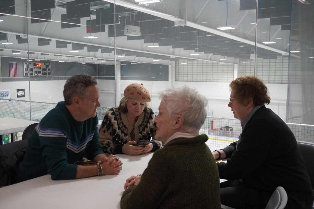 People sit at a table and talk.