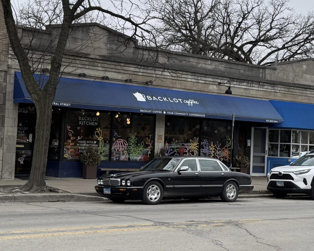 Brick building with awning that reads “Backlot Coffee”