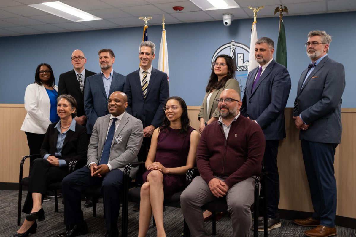 Eleven people pose for a group photo.
