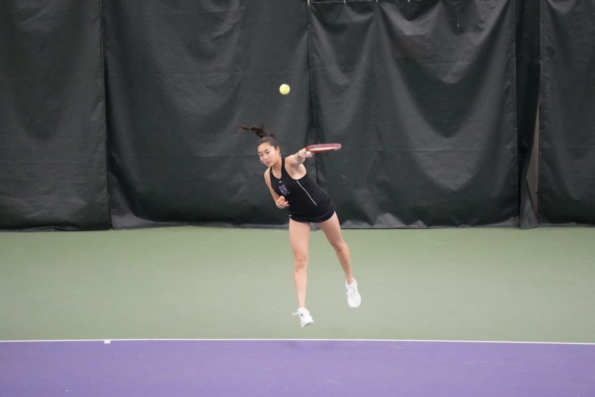 Freshman Margot Phanthala serves the ball during Sunday’s match against DePaul. 