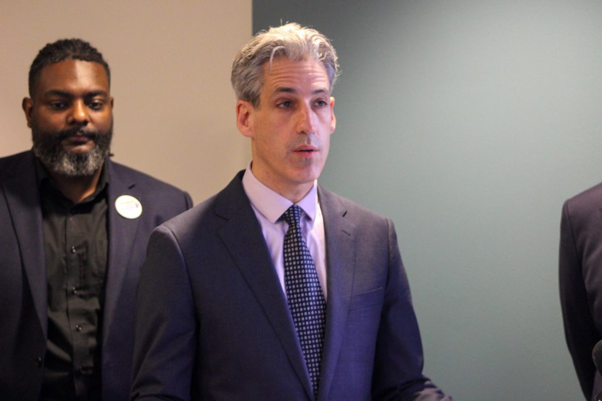A person in a suit speaks.