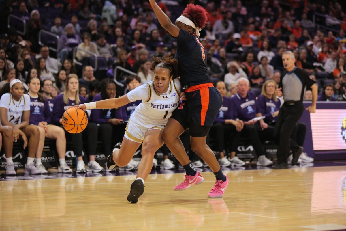 A person in a white jersey dribbles the basketball while colliding with a person in a dark jersey.