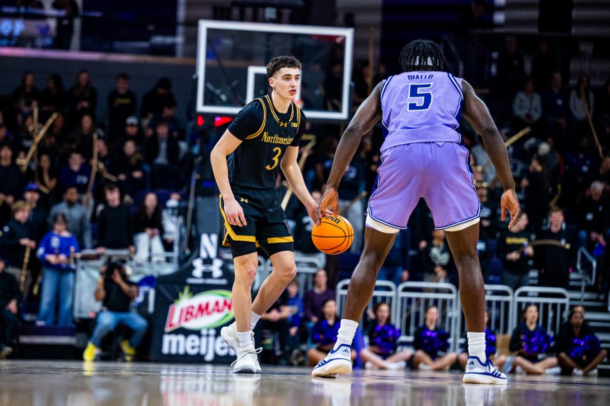 A player in black dribbles the ball up the court.