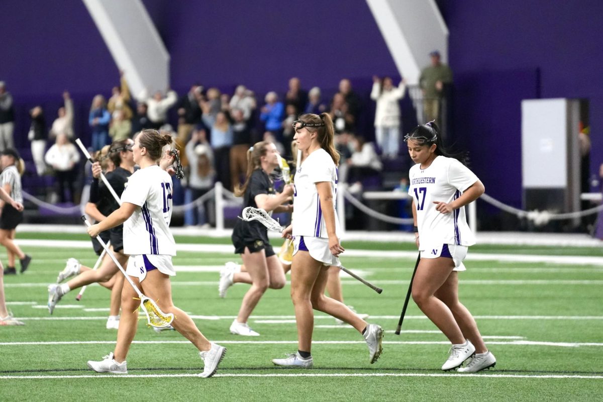 Northwestern players walk off the field after Monday’s upset loss to Colorado. 