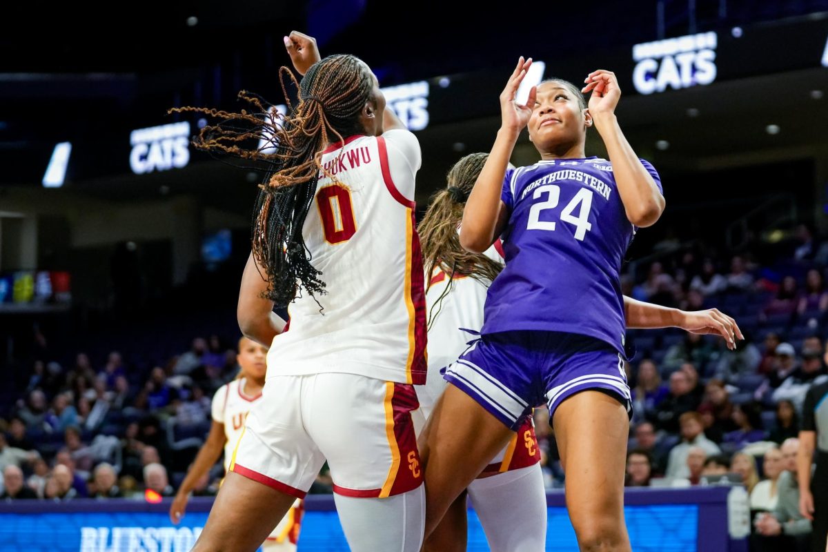A basketball player holds their hands up after making a pass.