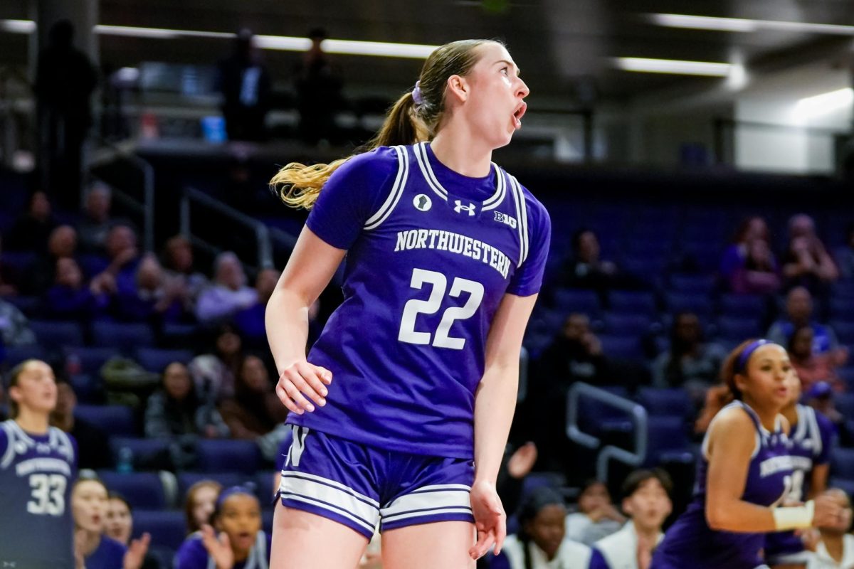 A basketball player clenches their fists in celebration.