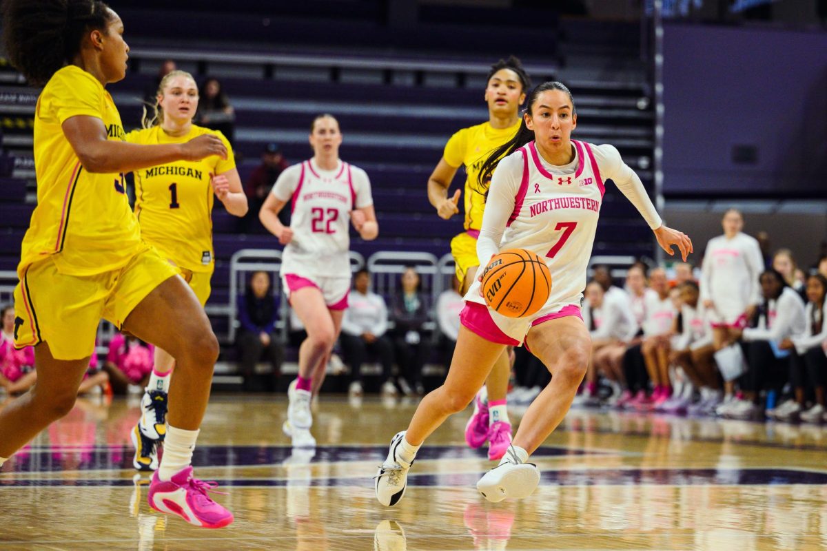 A player in white dribbles away from a player in yellow.