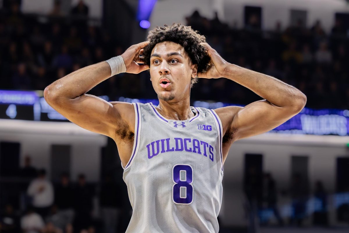 A Northwestern player holds their head in shock.