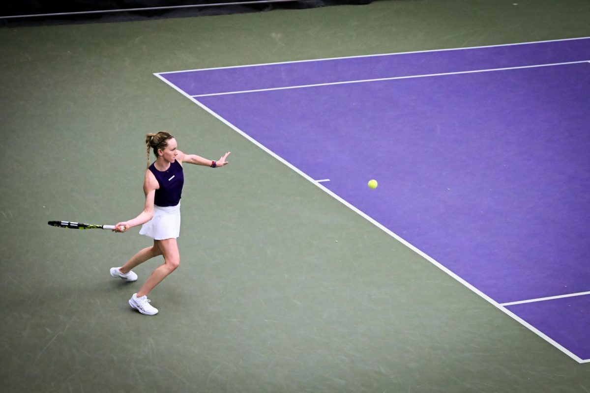 A tennis player in braids prepares a forehand hit.