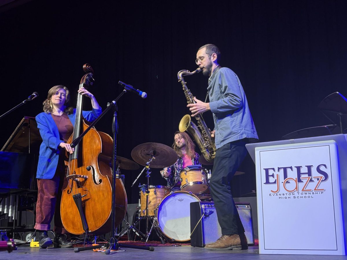 Twin Talk performs in Evanston Township High School auditorium next to Jazz Festival signage.