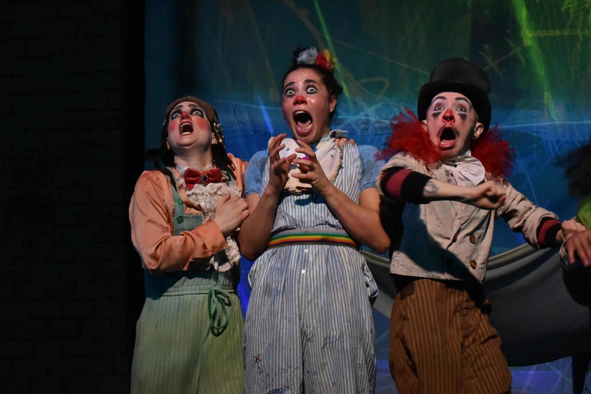 Three circus performers react in fear to the sound of thunder.