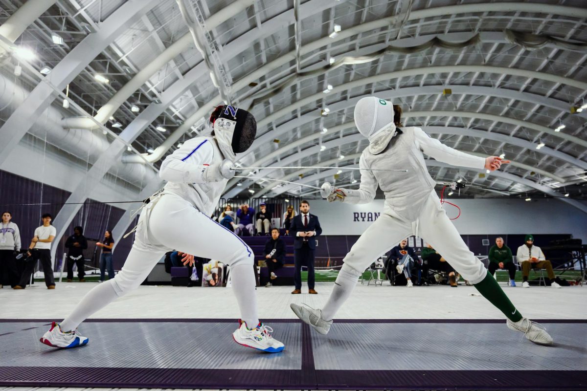 Sophomore foilist Brianna Ho lunges in against a Cleveland State opponent.
