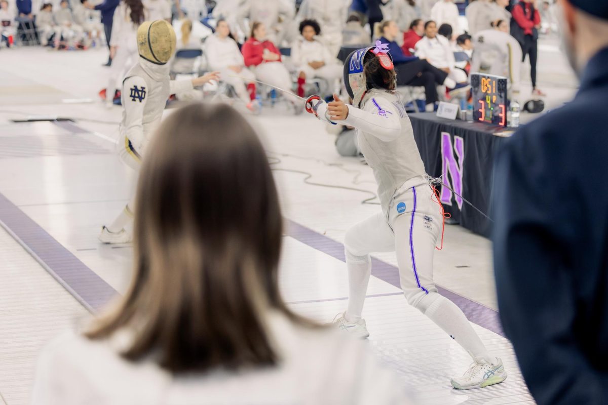 Two fencers stand apart, slowly shuffling towards each other.