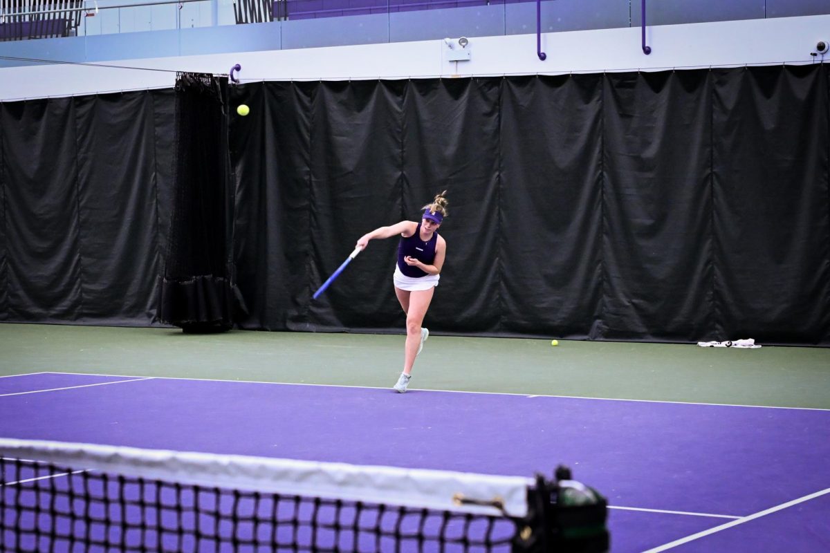 A tennis player serves the ball. 