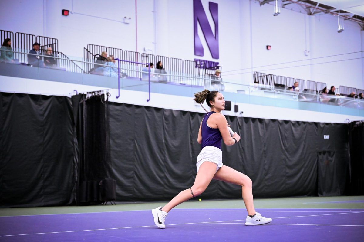 A tennis player recovers after a point. 