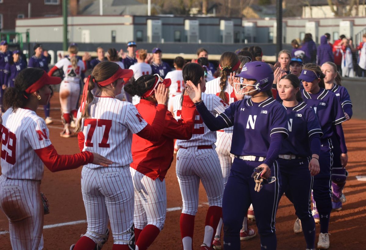With seniors Kansas Robinson and Kelsey Nader leading the way, Northwestern high-fives its opponents after a game last season. 