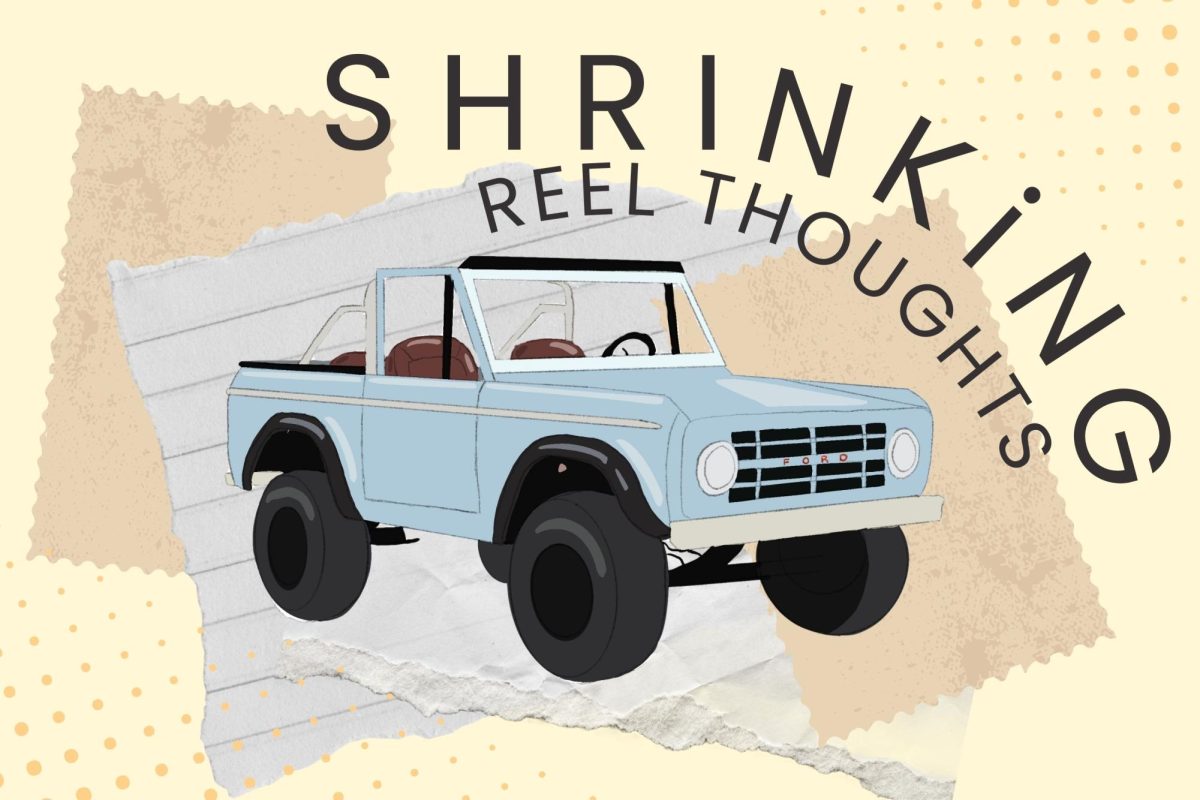A blue rustic car with an open roof sits before a banner reading “SHRINKING, REEL THOUGHTS.”