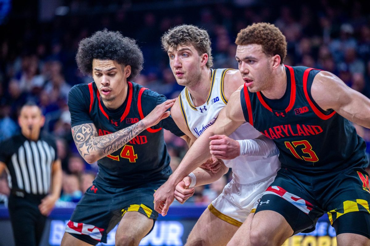 Players in black and white jerseys fight for a rebound.