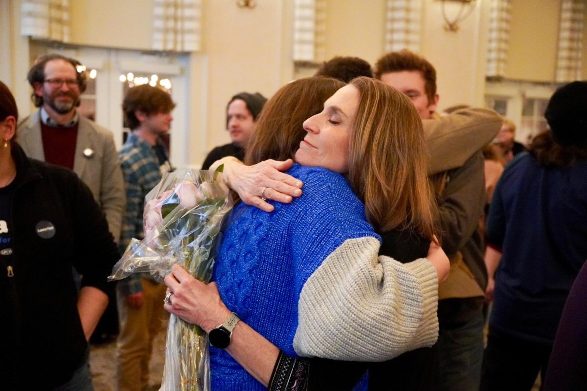 A person embraces another.