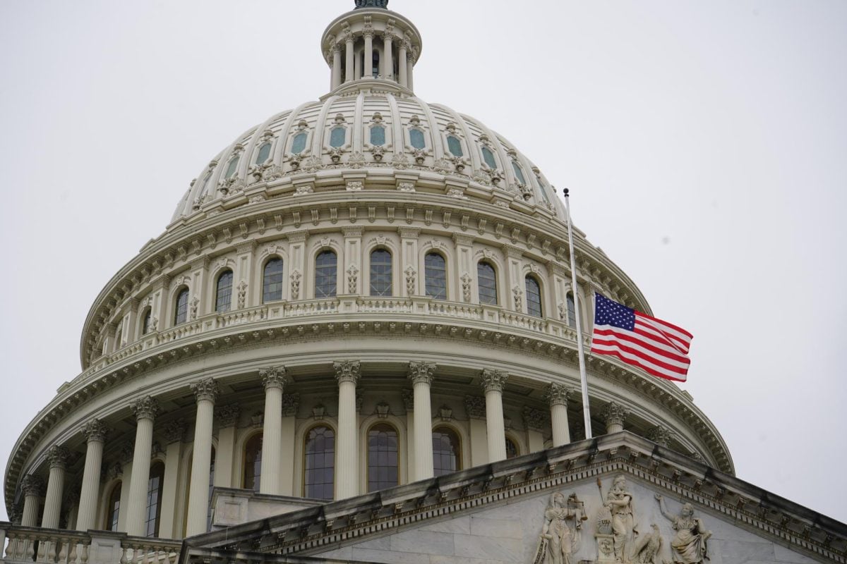U.S. flag set against the U.S. Capital building.