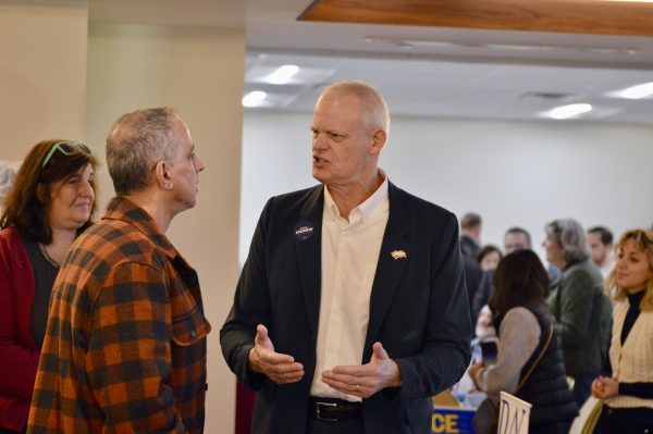Two men talk to each other