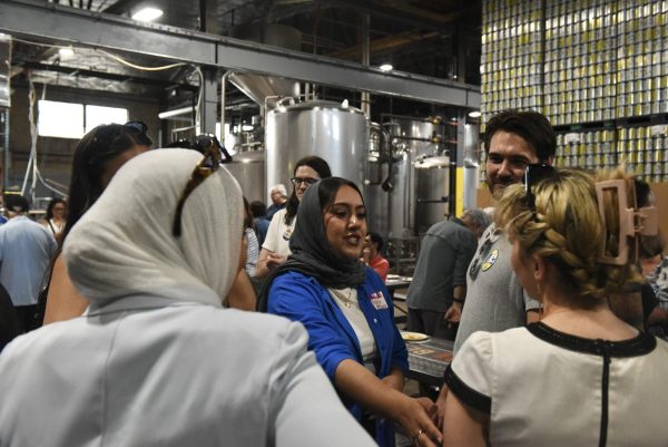 A woman reaches out in a crowd