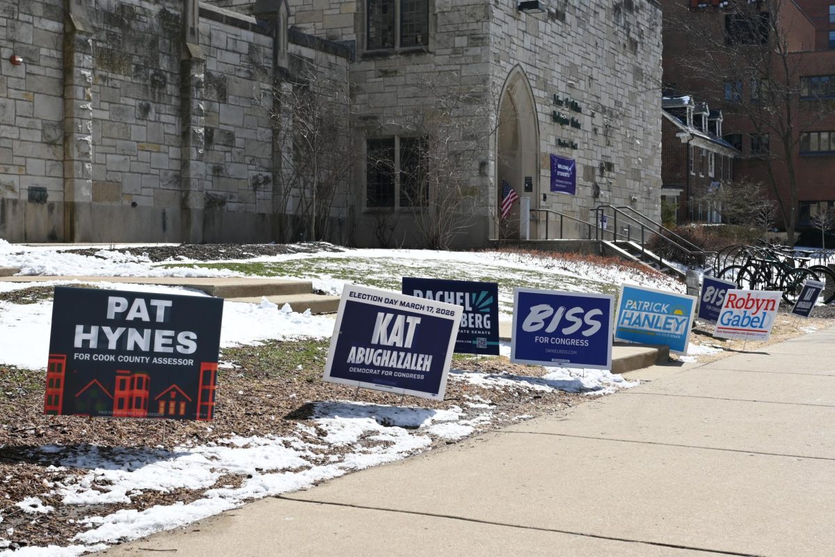 Yard signs line the pavement outside the entrance to the Parkes Hall voting room.