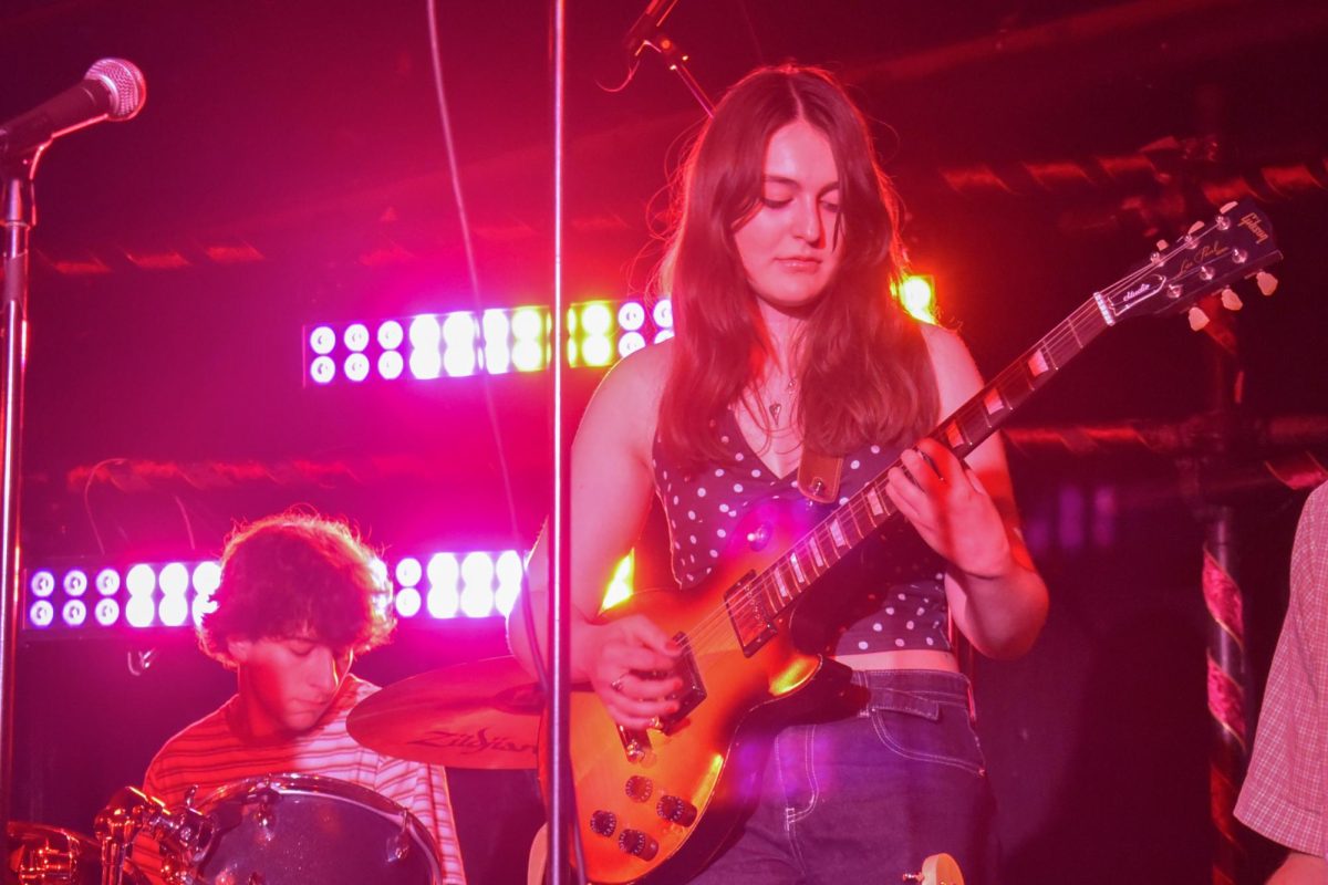 A musician plays an electric guitar. 