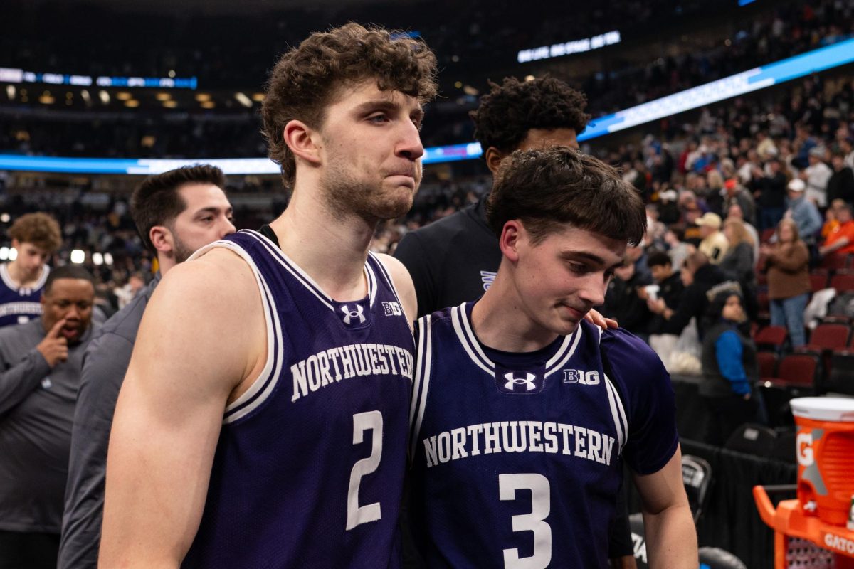 Two players in purple jerseys solemnly walked off the court in embrace.