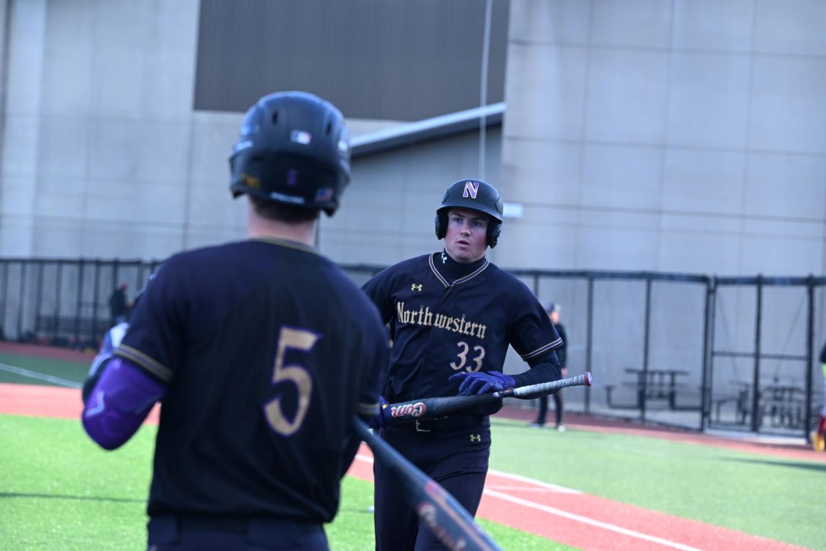 A player in a black jersey runs around the bases.