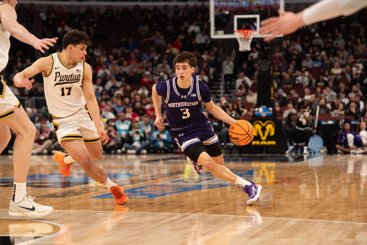 A player in a purple jersey dribbles toward the hoop.