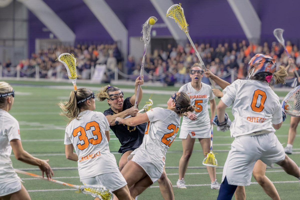 A Northwestern player shoots through a horde of defenders.