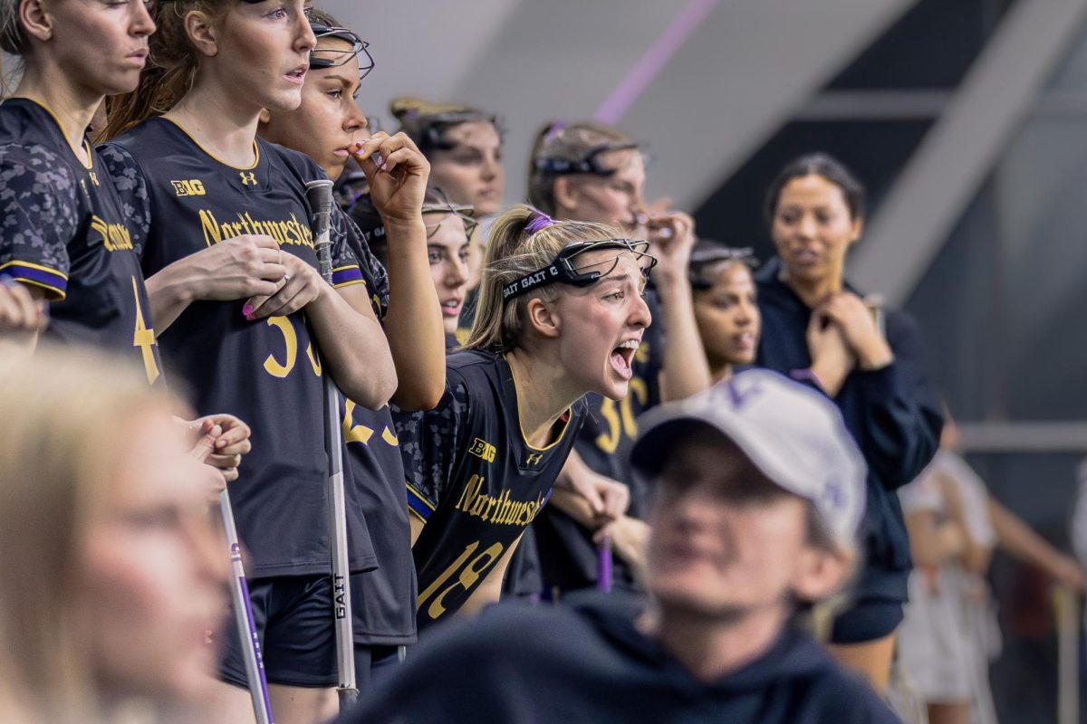 A Northwestern player on the bench shouts to their teammates.