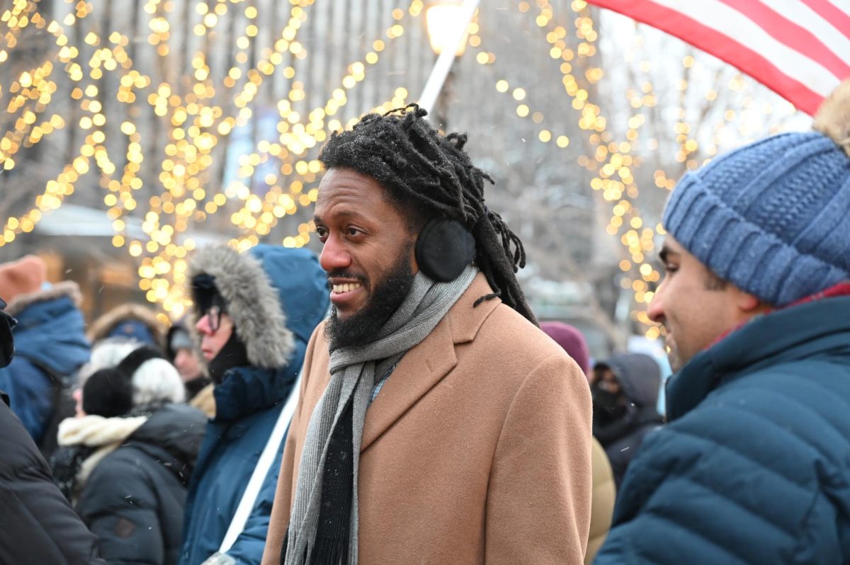 A man stands outside in a crowd.