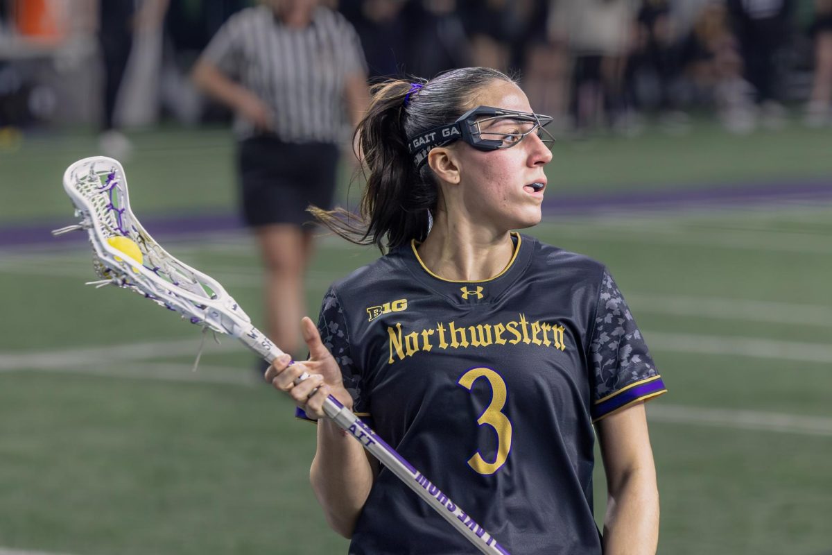 A Northwestern player bites their tongue while looking to pass.