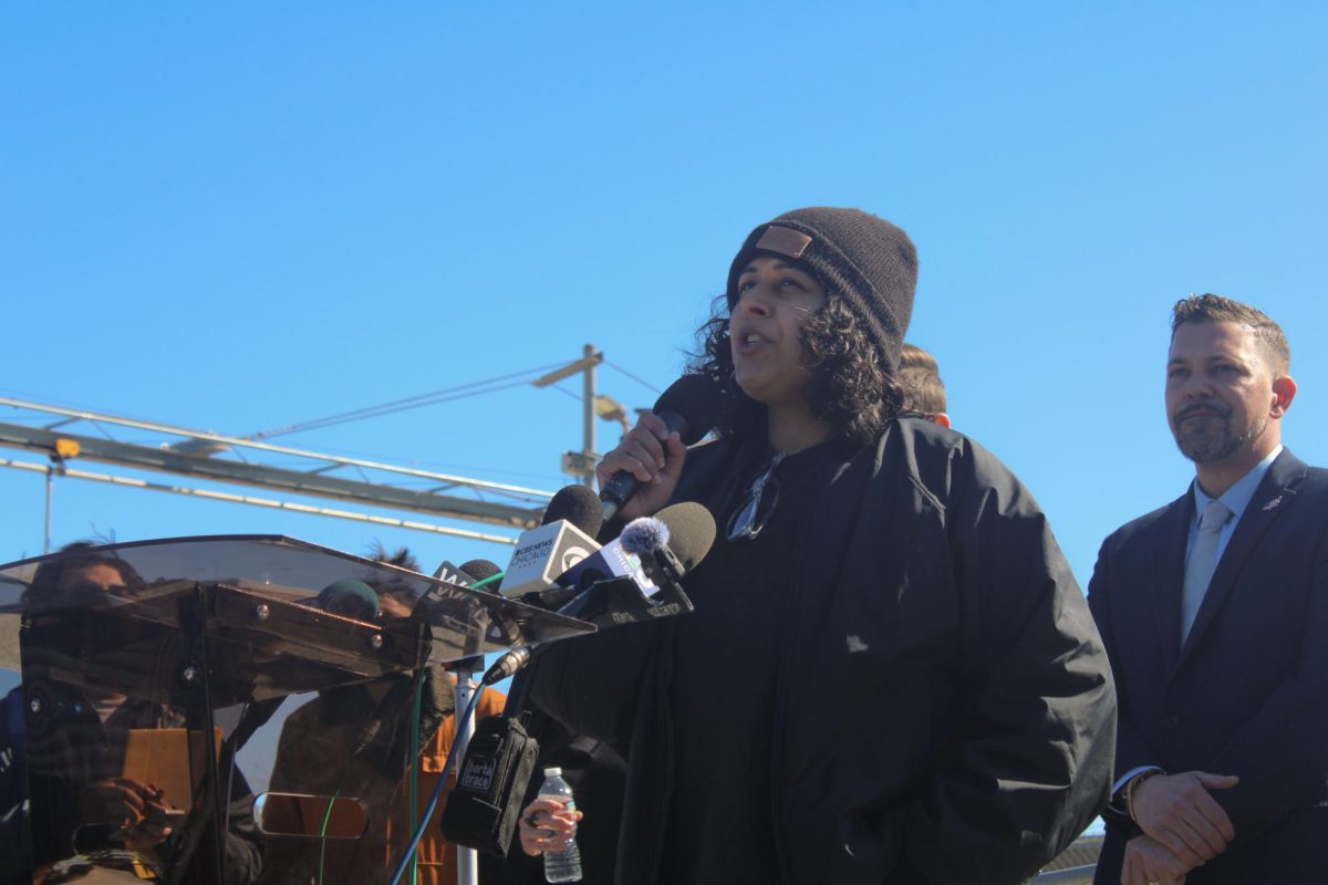 A woman speaks into a microphone.