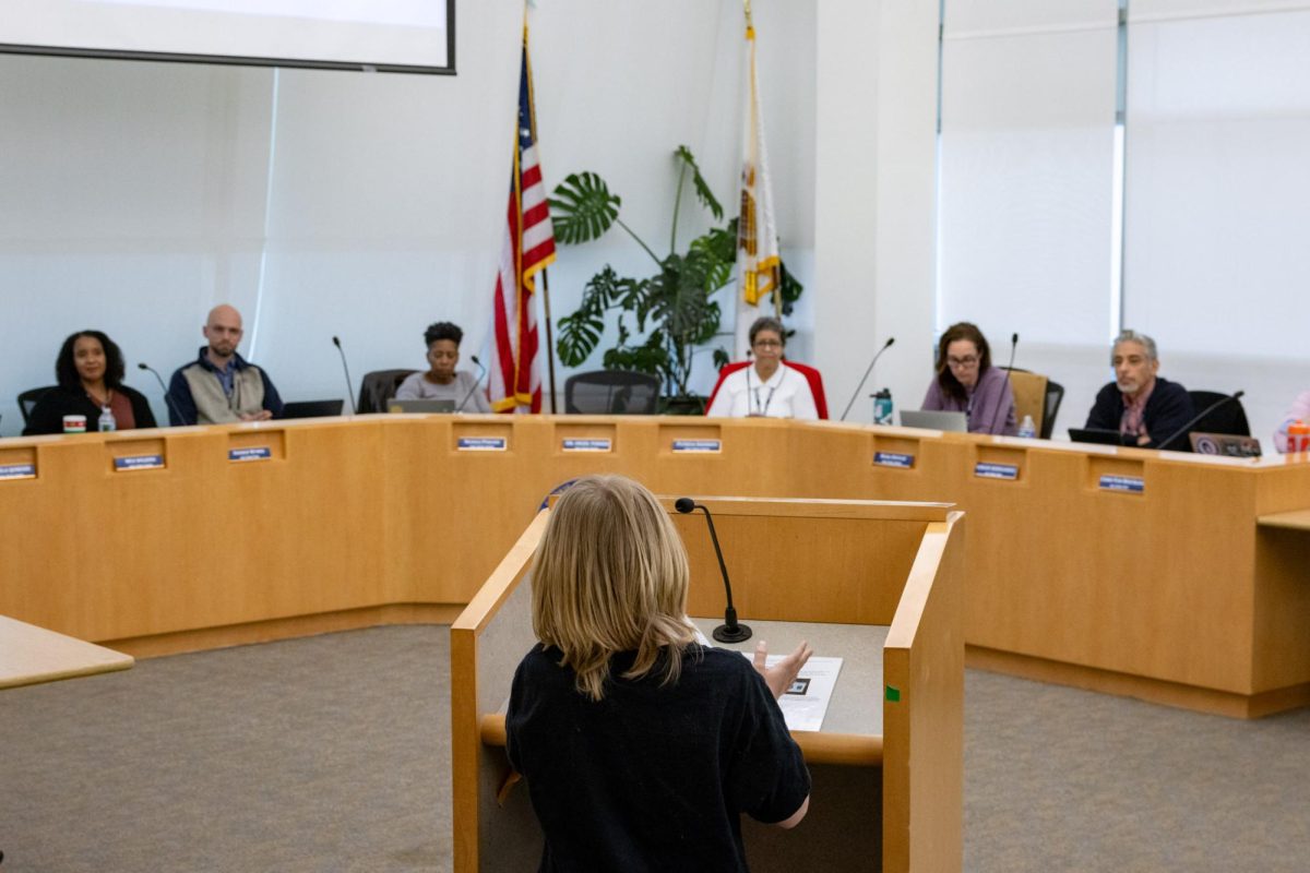 A child addresses a row of adults.