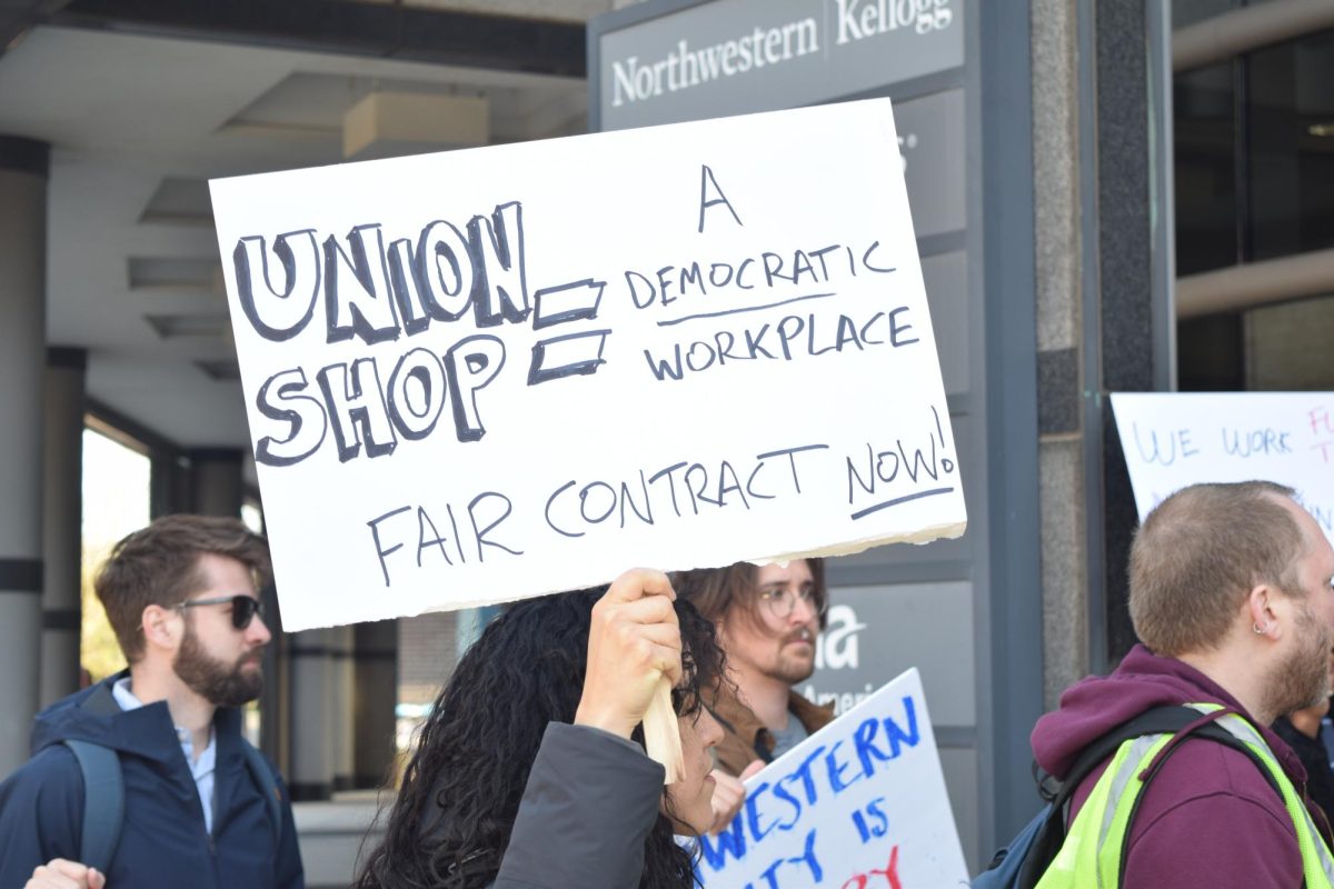 A sign is held up at a protest.