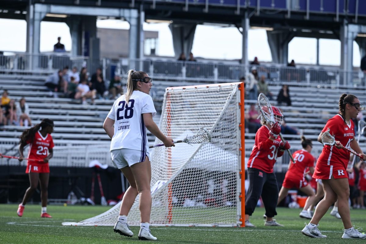 A player in a white jersey watches their teammates.