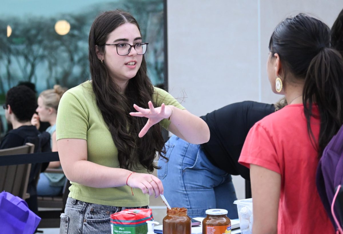 A person gestures while talking to another person. 