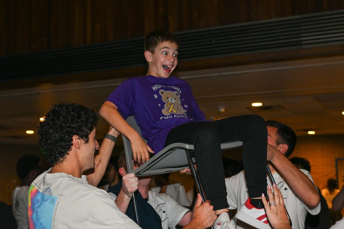 Child is lifted on a chair.
