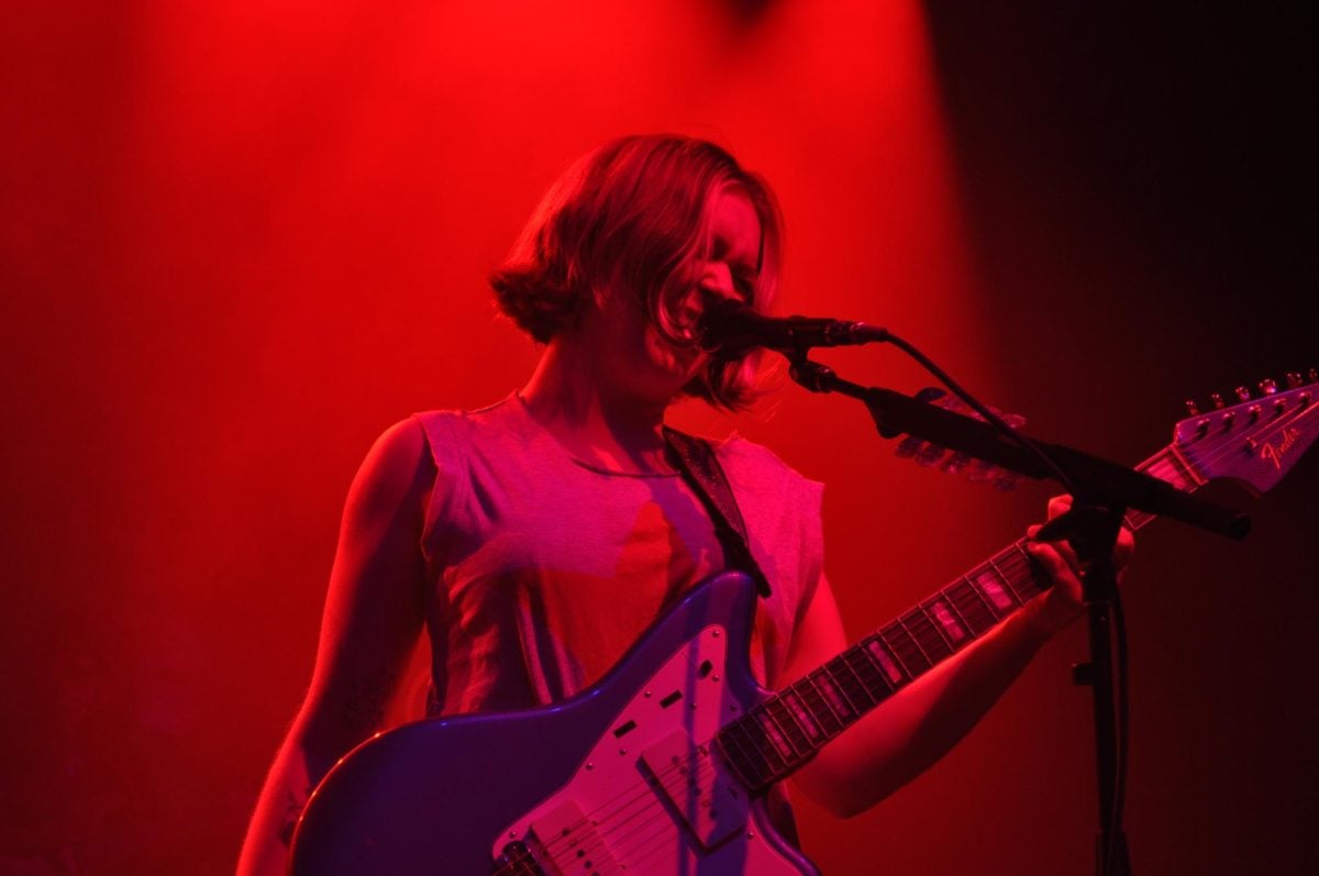 Red light on a person playing a guitar.