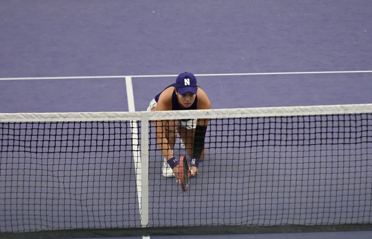 A player prepares to serve in a doubles match.